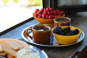 Summer breakfast on the veranda. Coffee, fruit and cookies.