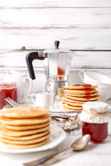 Tasty breakfast. Pancakes with strawberry confiture and butter.