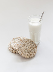 Crunchy round whole-grain сrispbreads made of rice, wheat, buckwheat with milk on a light background