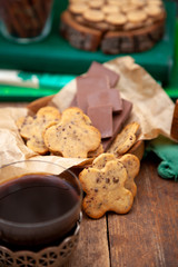 Homemade chocolate chip cookie. Baking, sweet snack. Food on a wooden table. Rustic style. Cooking at home. Chocolate for coffee.