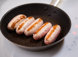 sausages are fried in pan. semi-finished products.