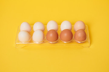 Eggs on a yellow background. Chicken eggs on a wooden board