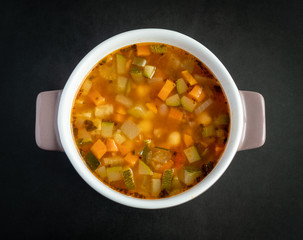 Vegeteable soup on wooden black table, high resolution photo