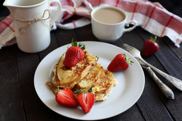 toast fried with egg with strawberries and coffee for Breakfast