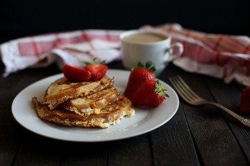 toast fried with egg with strawberries and coffee for Breakfast