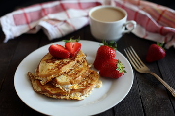 toast fried with egg with strawberries and coffee for Breakfast