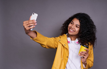 Young beautiful African woman takes a selfie.