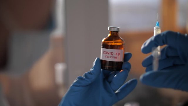 Medical doctor or laborant holding tube with nCoV Coronavirus vaccine for 2019-nCoV COVID virus. Novel Coronavirus originating in Wuhan, China. Coronavirus 2019-nCoV COVID concept.