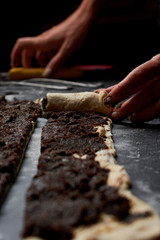 Baker prepares homemade cakes. Professional Female cook sprinkles dough with flour, prepared for baked bread