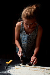 Baker prepares homemade cakes. Professional Female cook sprinkles dough with flour, prepared for baked bread