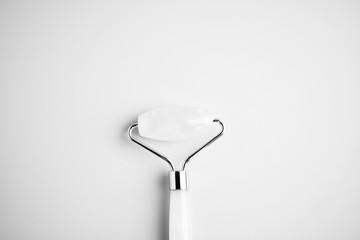 Roller for face massage, rejuvenation in monochrome tone of gray color.