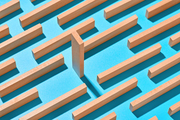 Wooden yellow planks on a light blue background are arranged diagonally in an abstract geometric...