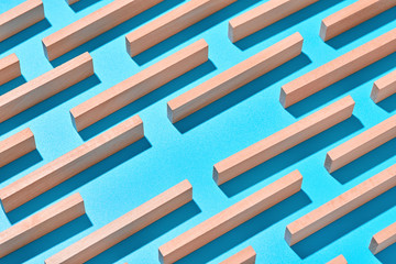 Wooden yellow planks on a light blue background are arranged diagonally in an abstract geometric pattern. Abstract background.
