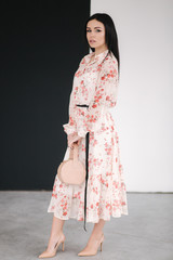 Young brunette model demonstating spring clothes in studio