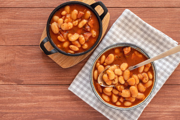 Beans stew with sausages in a bowl