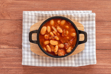 Beans stew with sausages in a bowl