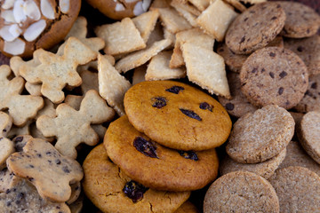 A set of different homemade cookies. Cookies close-up. Background from delicious pastries. Cookie with coconut, mishdal, chocolates, raisins, lingonberries. Round, rhombuses, bears, flowers shapes.