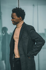 Black businessman smiling near to a building