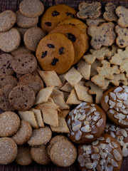 A set of different homemade cookies. Cookies close-up. Background from delicious pastries. Cookie with coconut, mishdal, chocolates, raisins, lingonberries. Round, rhombuses, bears, flowers shapes.