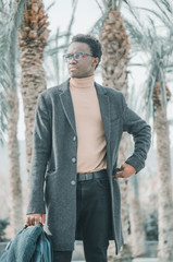 Young and black businessman looking towards the sea