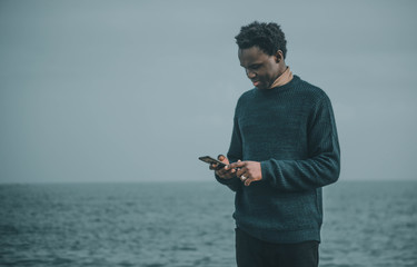 young man writing in his smartphone