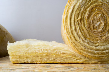 roll of mineral wool lying on the wooden floor
