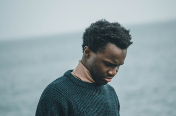 young man on the beach thinking about life