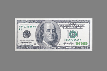 USA money - 100 dollars with a portrait of American President Franklin on an isolated neutral gray...