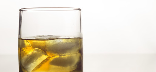 glass of whiskey with ice on a white background