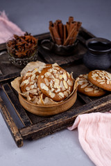 Sweet almond cookies  on wooden table.French homemade cookie. Useful Lenten cookies from almond flour with honey on rustic wooden background. Selective soft focus.