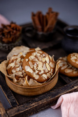 Almond Chip Cookies. Almonds on a round homemade cookie. Still life, food closeup on a wooden table. Appetizing pastries.