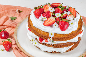 Strawberry cake, strawberry sponge cake with fresh strawberries and sour cream on a white background