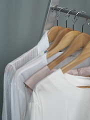 Storage of white and light items on the shoulders of hangers, products made of natural fabrics