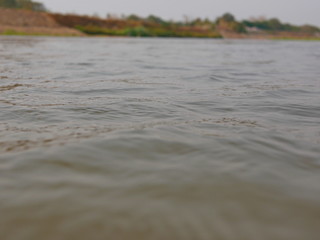 Close up and selective focus of flowing river surface