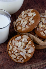 Sweet almond cookies  on wooden table.French homemade cookie. Useful Lenten cookies from almond flour with honey on rustic wooden background. Selective soft focus.