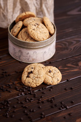  Dietary cookies with dark chocolate on a wooden background.