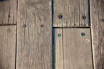 Close-up of brown weathered boardwalk planks background.