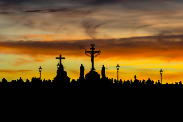 Silhouettes of Charles Bridge (Karluv Most) statues during yellow sunset