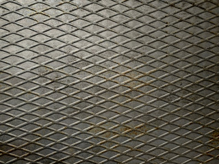 Rusty gray metal texture with a diagonal mesh. Shallow grid of steel wall texture. Speaker grill texture.Background for grunge design poster, invitation, cheeky party.