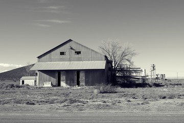 Black and white filter on building that out of business along the road