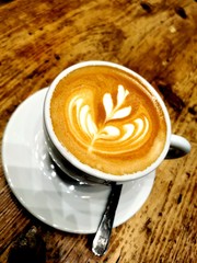 Cappuccino with beautiful drawn flower using Latte Art