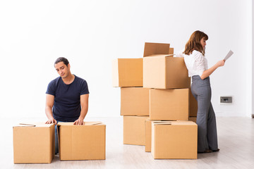 Young pair and many boxes in divorce settlement concept