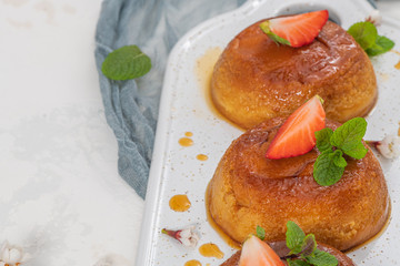Caramel custard pudding  on plate over modern background with copy space.