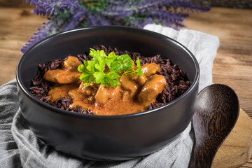 Thai red curry with chicken and black rice.