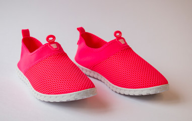 women's pink sneakers on a white background