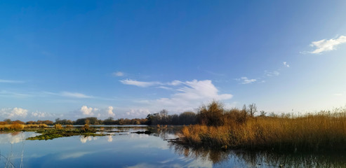 Reflection in the river of clouds and blue sky