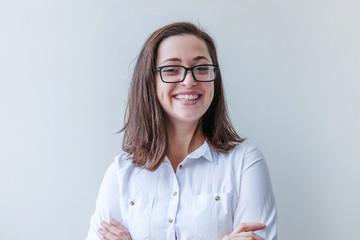 Beautiful happy girl smiling. Beauty simple portrait young smiling brunette woman in eyeglasses isolated on white background. Positive human emotion facial expression body language. Copy space