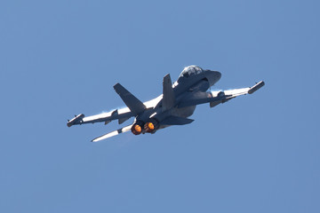 Tail view of a EA-18G Growler in beautiful light, with afterburners on