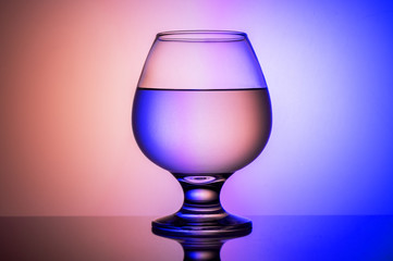 Cognac glass with a colorful background. Beautiful background and a glass.