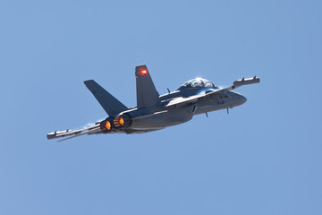 Tail view of a EA-18G Growler in beautiful light, with afterburners on